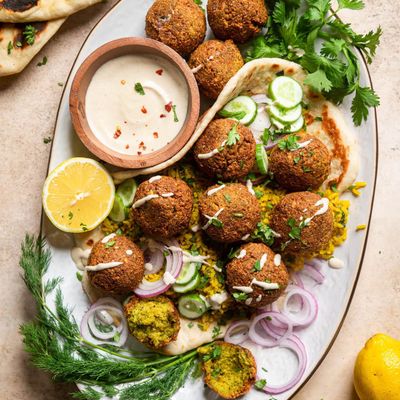 Fried falafel balls, cut in half to show the green interior