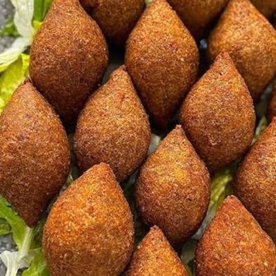 Fried kibbeh, diamond-shaped, arranged on lettuce leaves